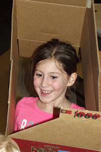 girl playing in a box