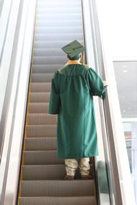 grad on escalator