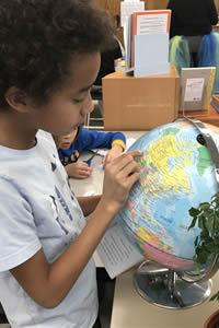 student looks at a globe