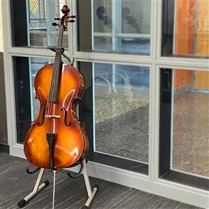A violin sits in front of a window in the classroom 