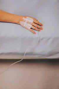 hand and hospital bed