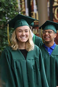 High school graduates in green gowns