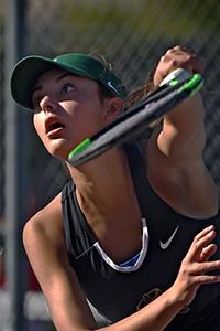 high school girl playing tennis