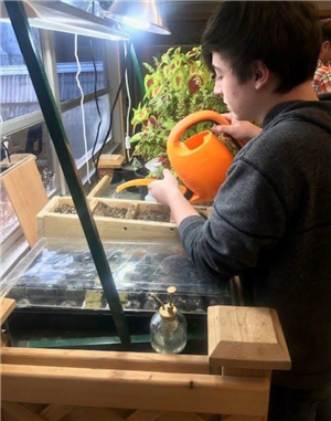 student watering plants 